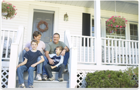 family sitting on house porch