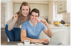 happy young couple at laptop computer