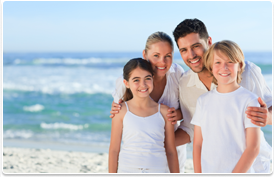 family smiling on beach